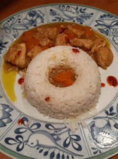 chicken with white rice and red yellow curry sauce