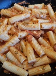 cooked italian pasta with creamy tuna, tomato and dill sauce