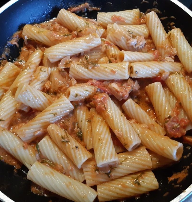 cooked italian pasta with creamy tuna, tomato and dill sauce