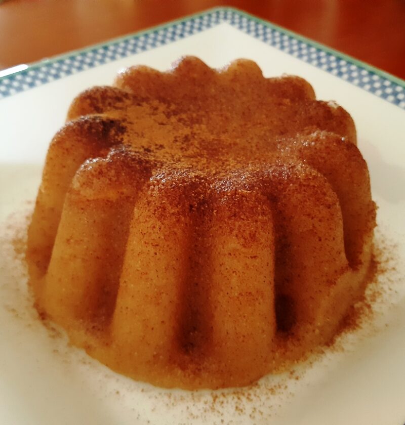 A white dish with a golden semolina pudding