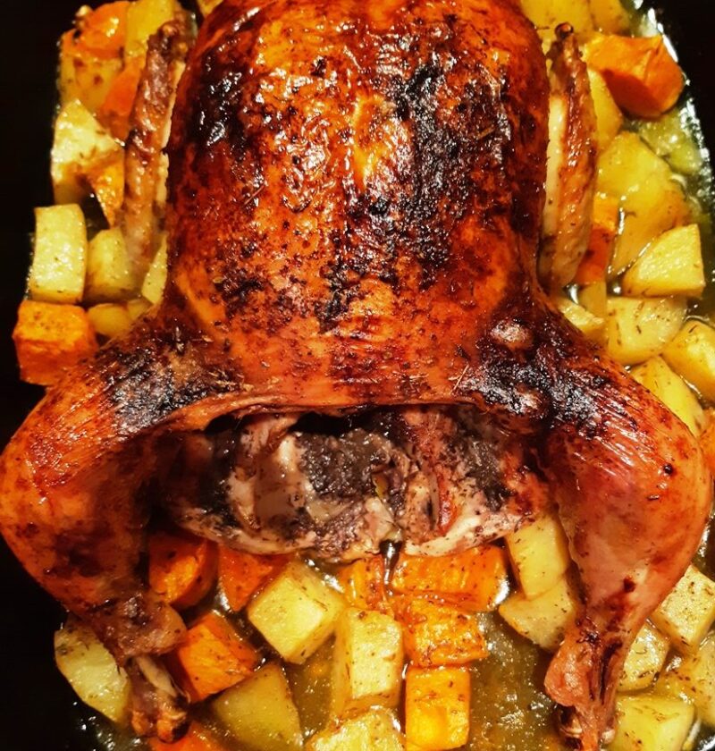 roast chicken with potatoes in a pan