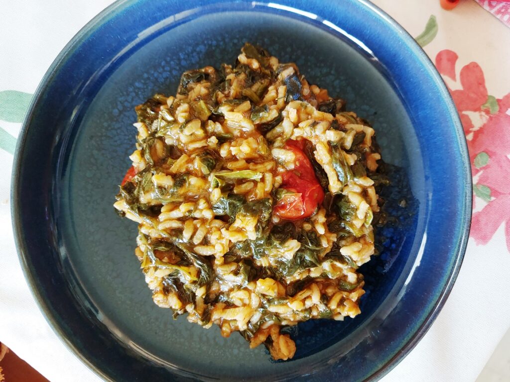 Blue dish with spinach risotto.